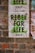 A weathered protest poster on a brick wall with the text 'REBEL FOR LIFE' in bold, green letters. The poster includes references to 'extinction rebellion' and details a date and location as '23 August London'. The background comprises rustic red and brown bricks, partly covered by remnants of other posters.