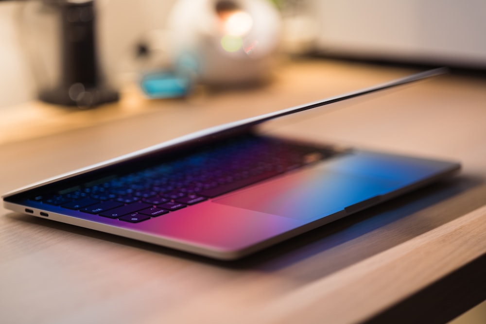 a laptop computer sitting on top of a wooden desk