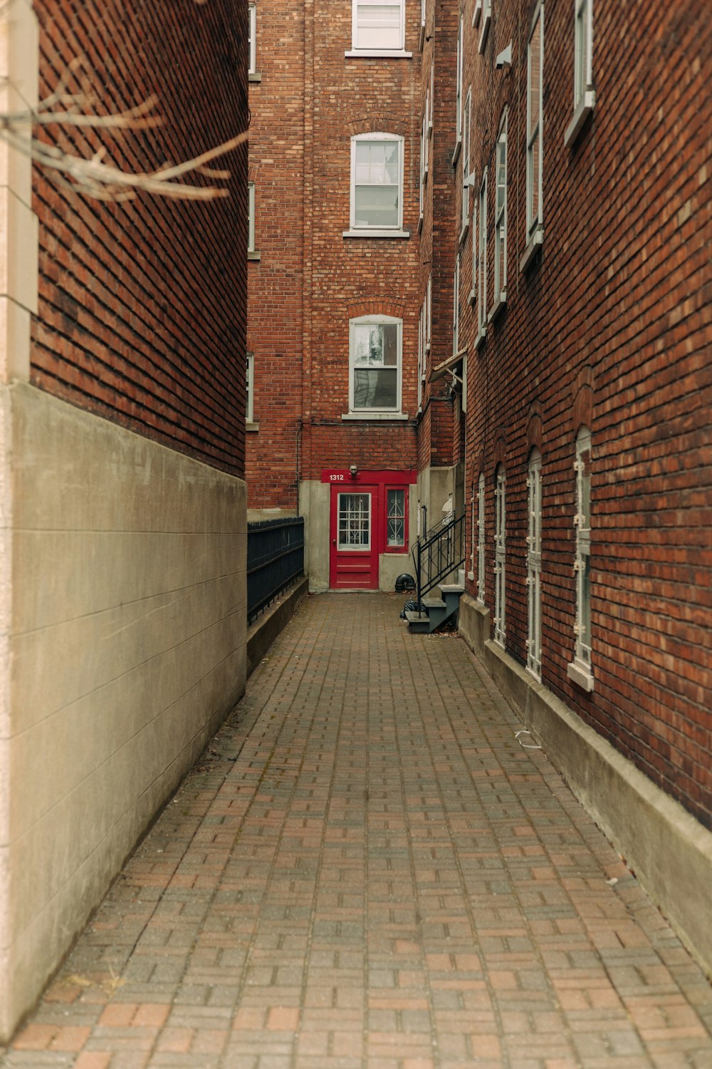 a red door is on the side of a brick building