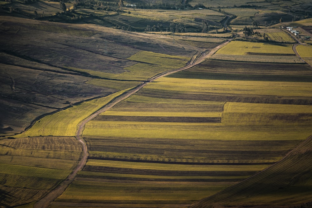 an aerial view of a field with a road running through it