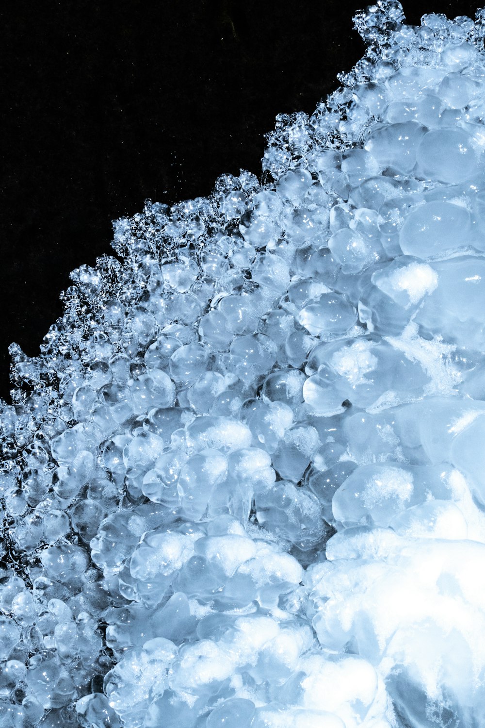 a close up of ice on a black background