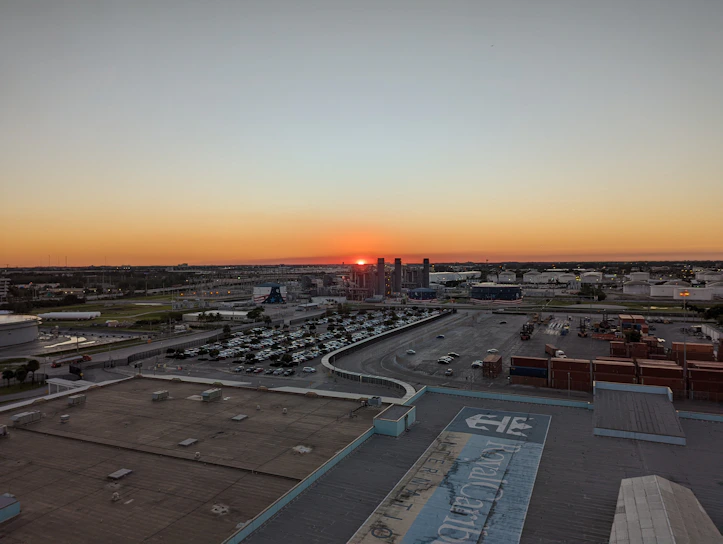 A panoramic aerial shot of a sprawling industrial park in Istanbul at sunset, highlighting modern warehouses and factories.