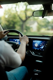 a man driving a car with a gps screen