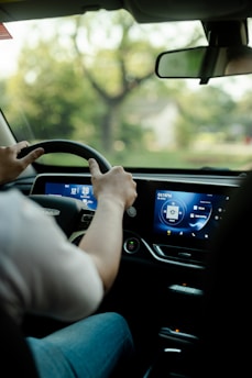 a man driving a car with a gps screen