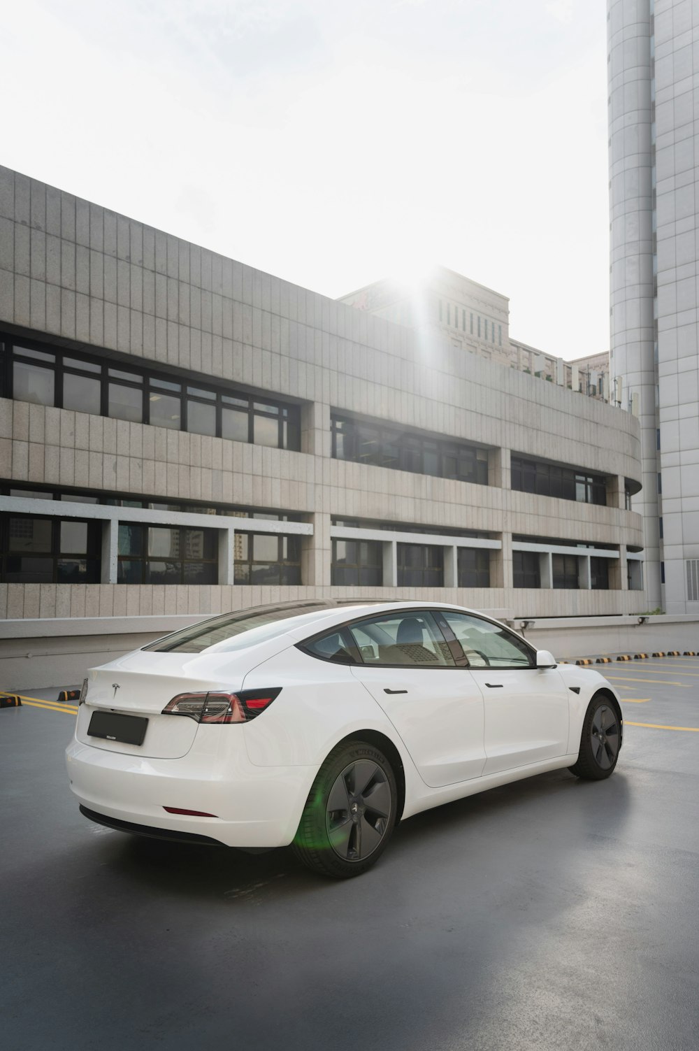 a white car parked in front of a building