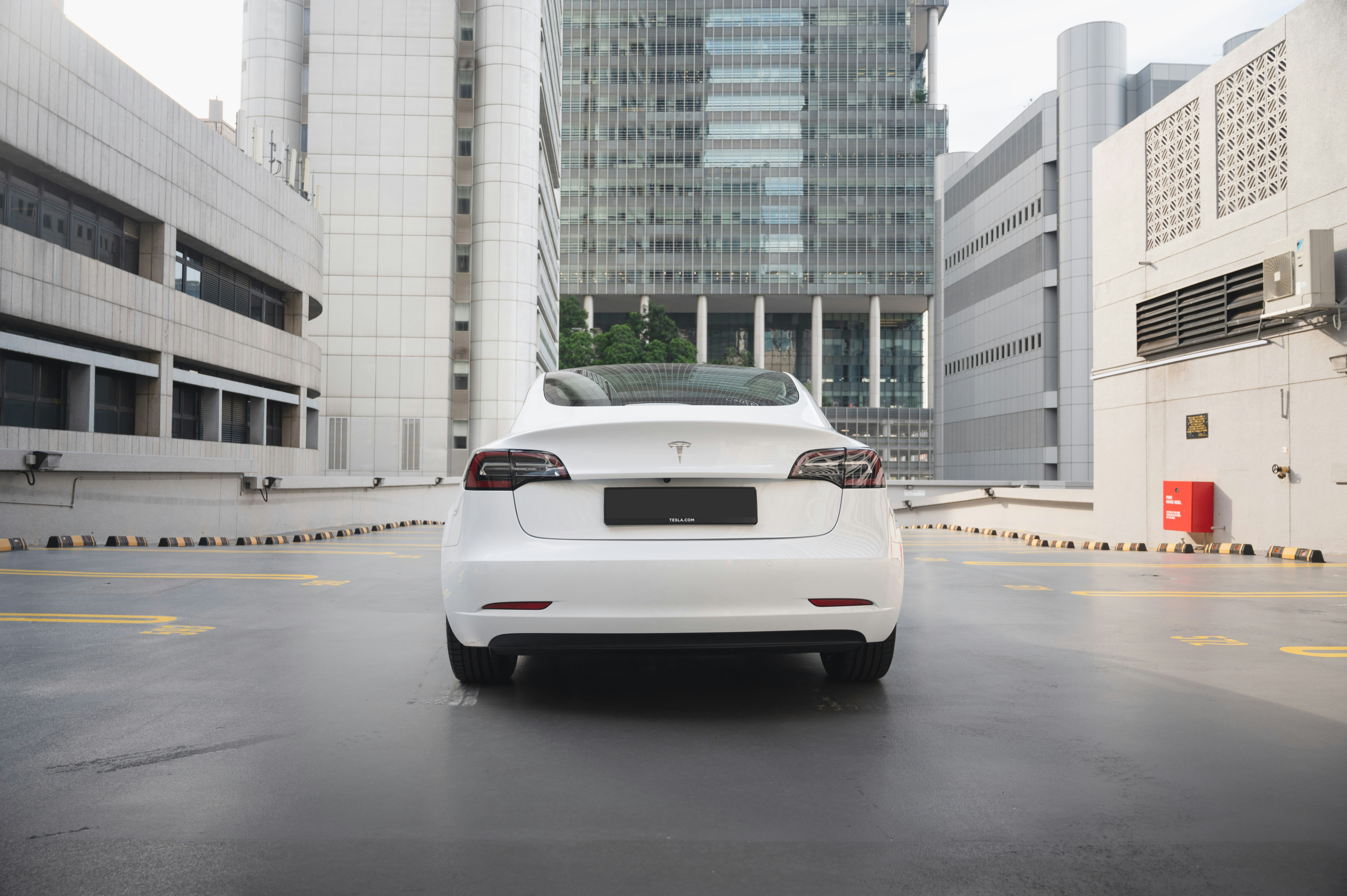 a white car is parked in a parking lot