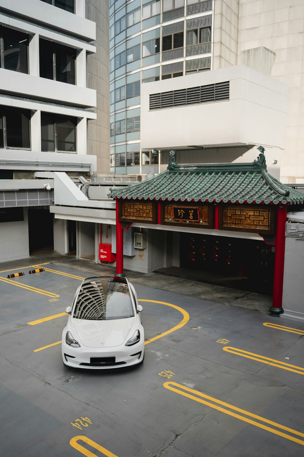 a white car is parked in a parking lot