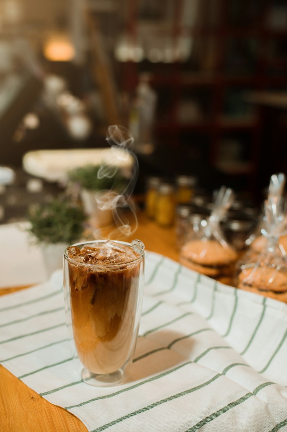 a cup of coffee sitting on top of a wooden table