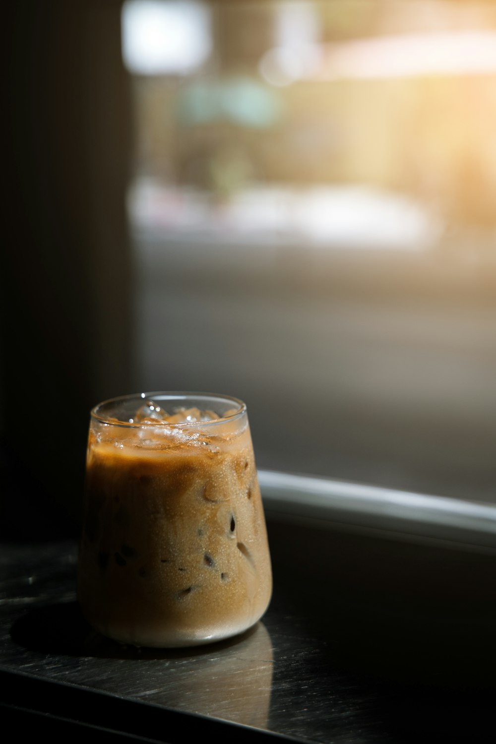 a cup of coffee sitting on top of a table