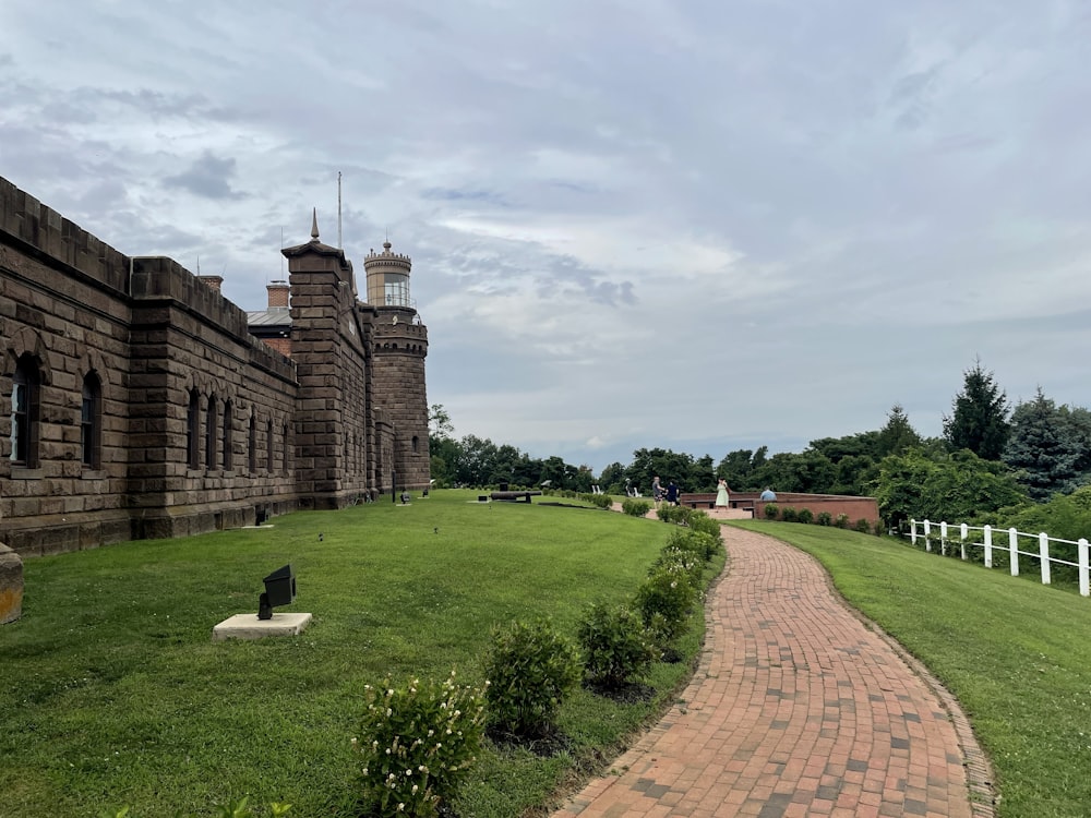 a brick path leading to a large brick building