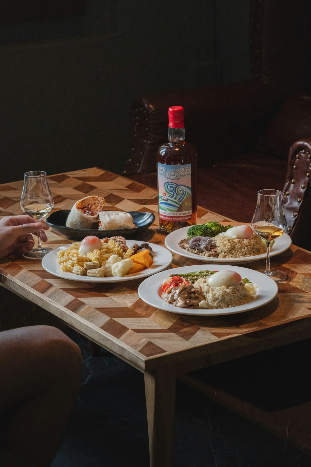 a person sitting at a table with plates of food