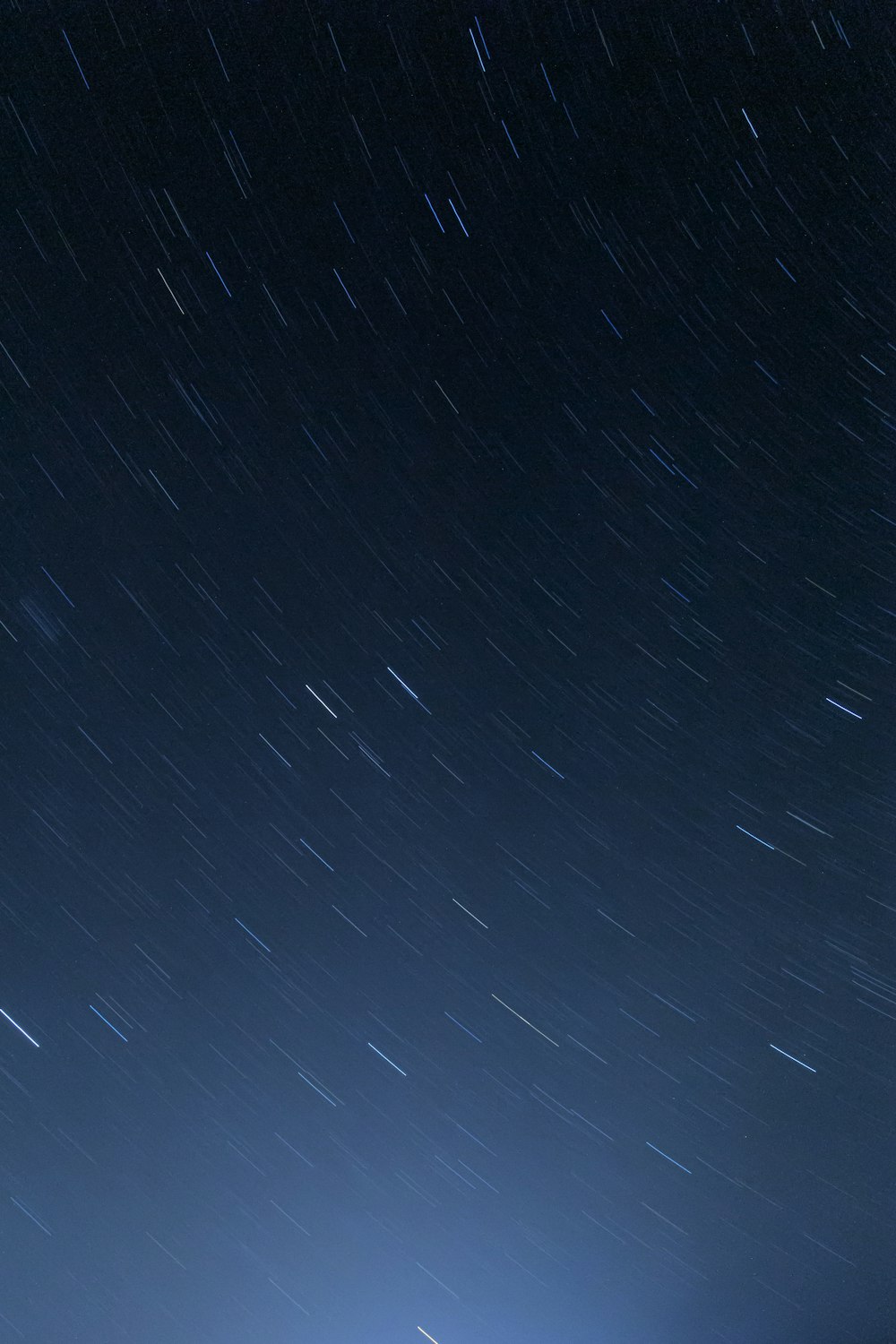 the night sky with stars above a building