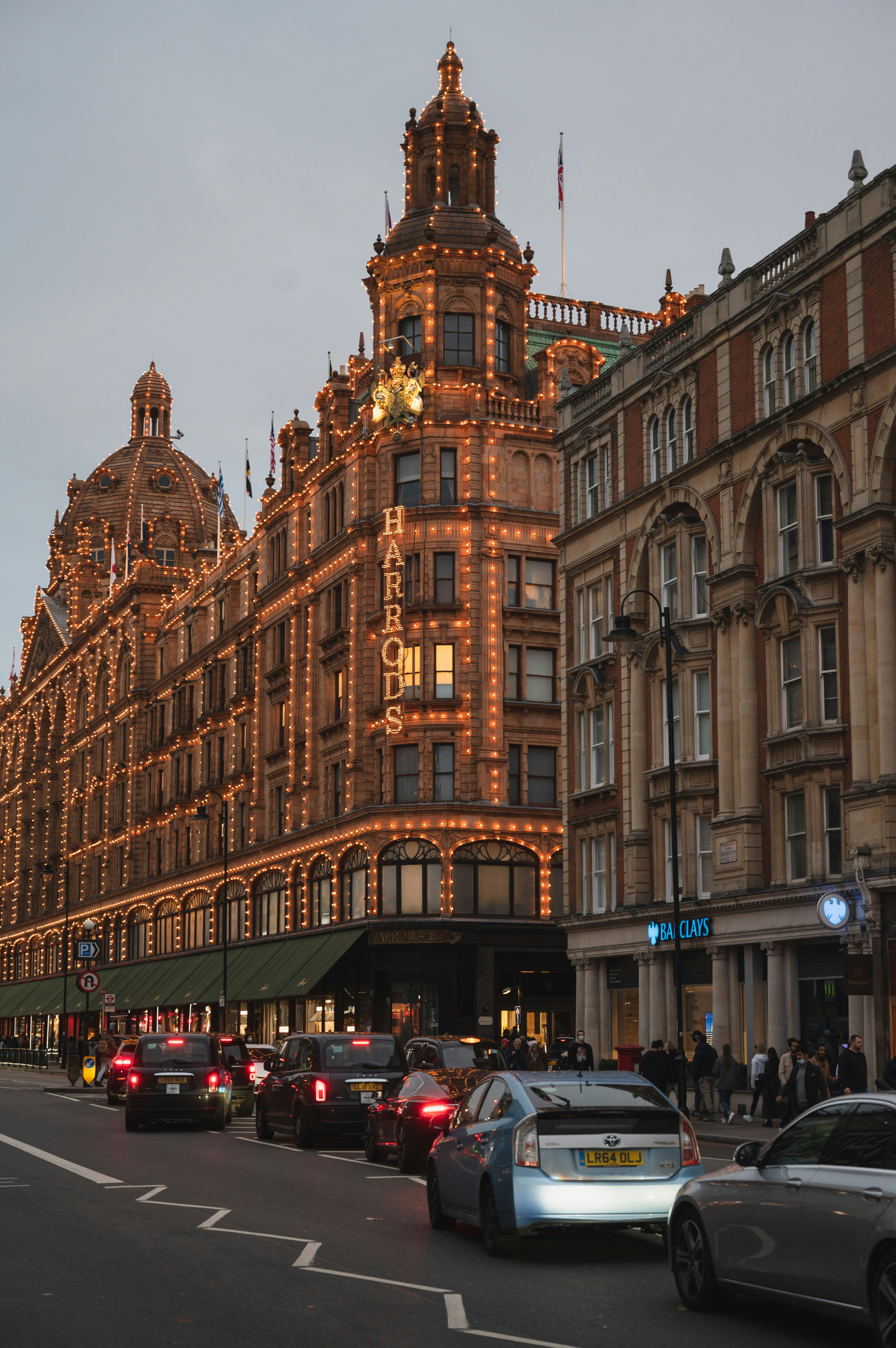 a very tall building with a lot of cars parked in front of it