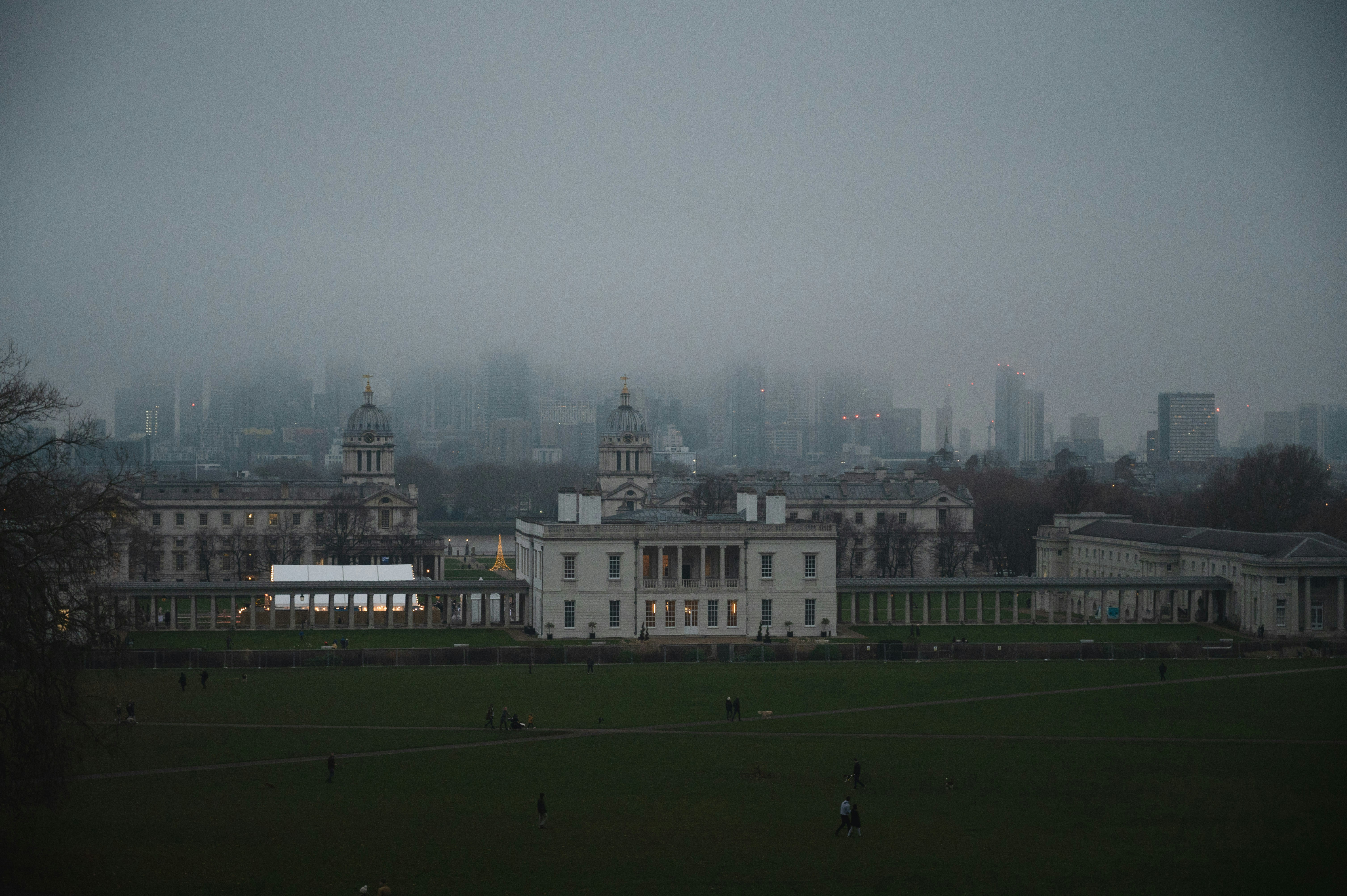 a view of a large white building with a city in the background