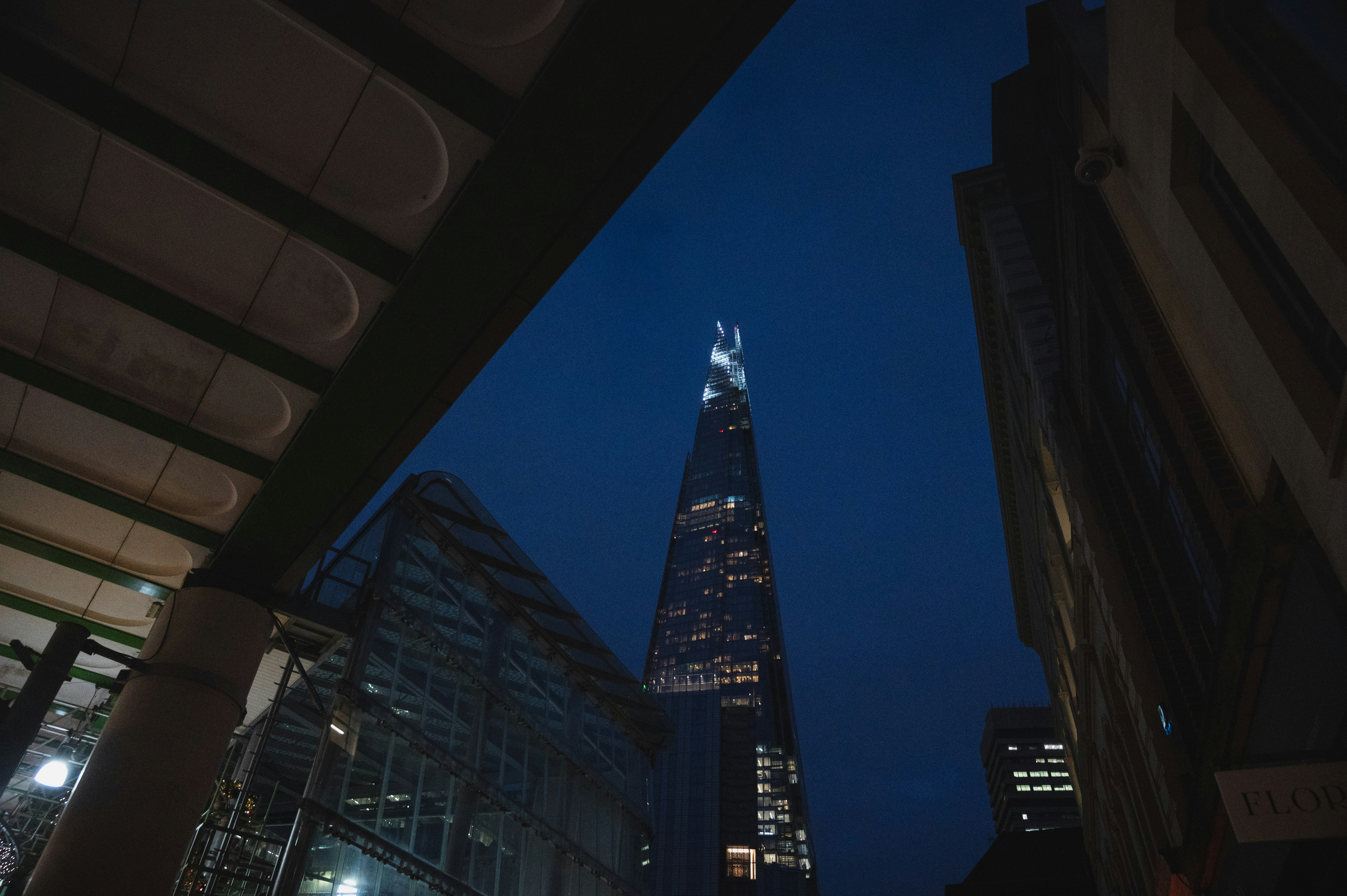 a very tall building towering over a city at night