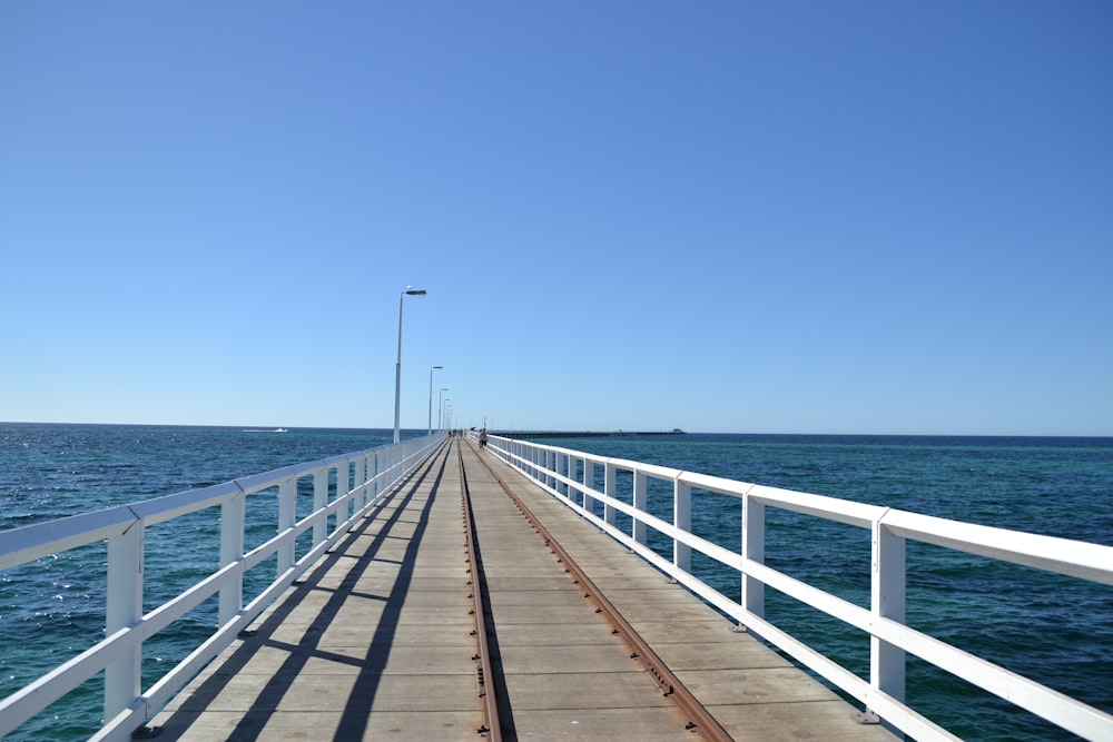 a long pier stretches out into the ocean