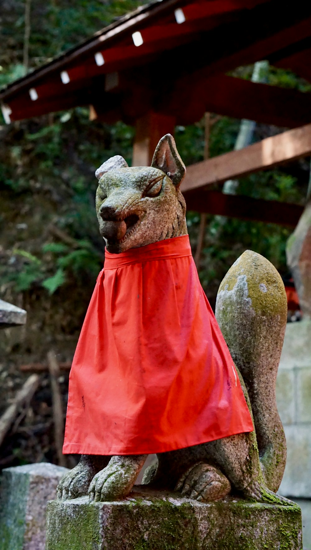 a statue of a squirrel wearing a red cape