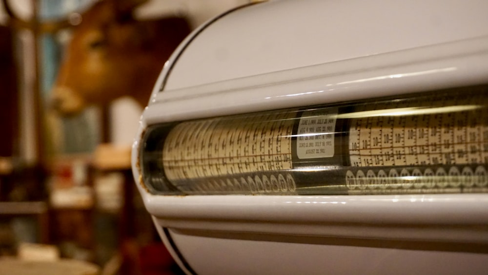 a close up of a microwave oven with a cow in the background