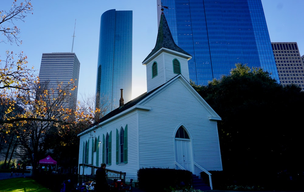 a church in a city with tall buildings in the background
