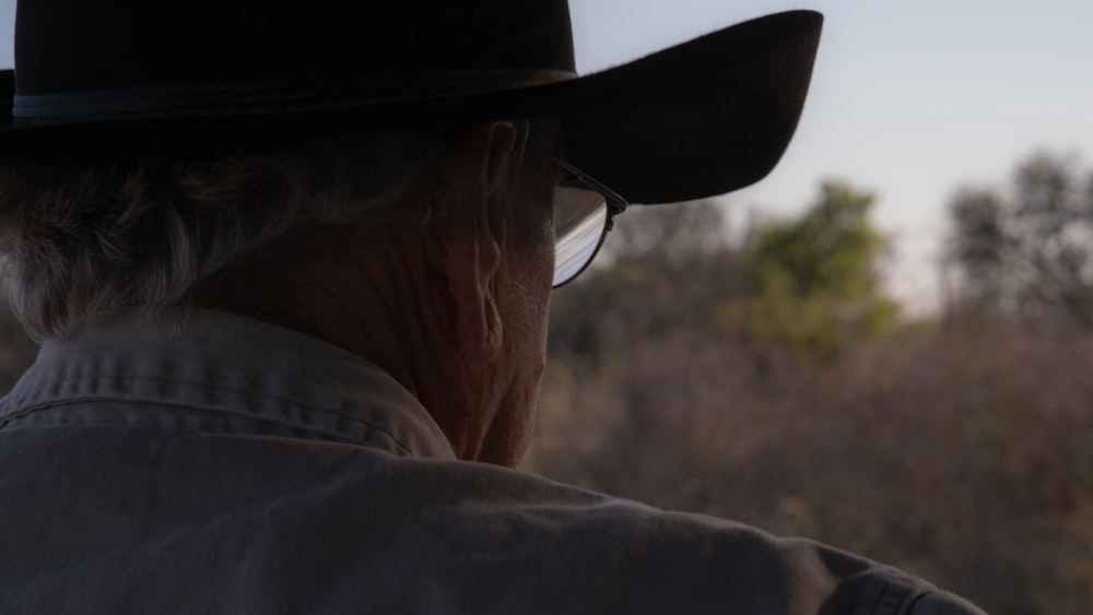 an old man wearing a hat and glasses