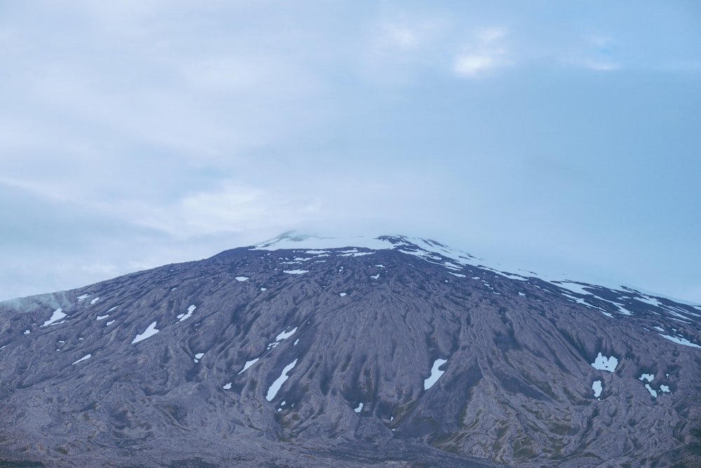 a large mountain covered in snow on a cloudy day