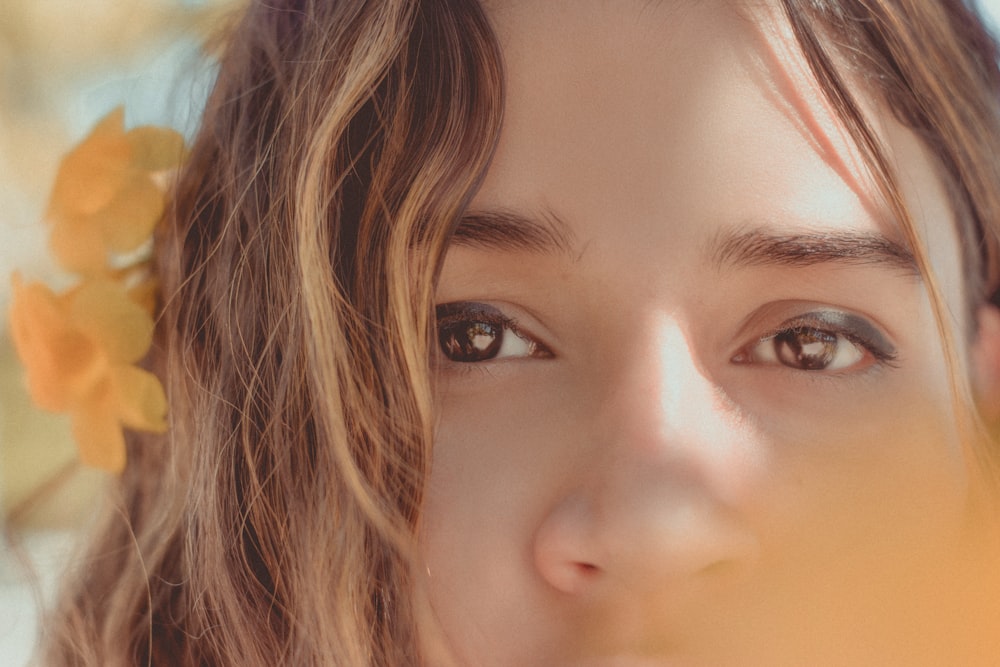 a close up of a person with flowers in her hair