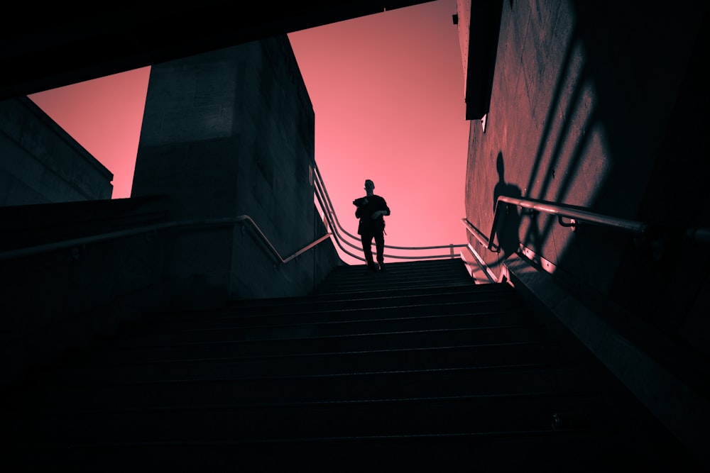 a person standing on a stair case in the dark