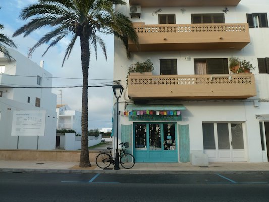 A bicycle outside a house with balconies — Formentera, Spain