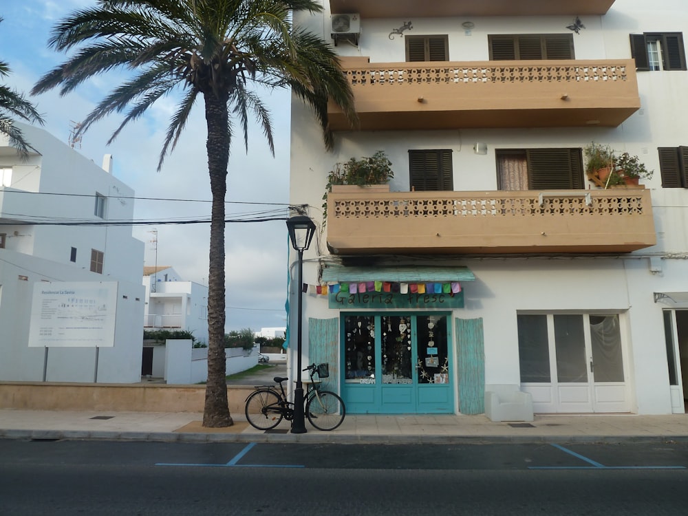 a bike parked in front of a building with balconies