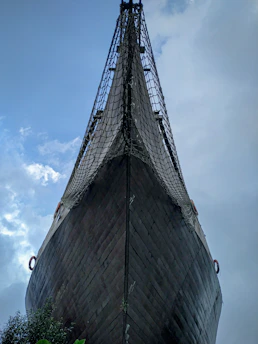 A weathered wooden ship sailing across a stormy Atlantic, symbolizing the transatlantic slave trade.