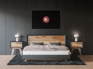 a bedroom with a bed, nightstands and a painting on the wall