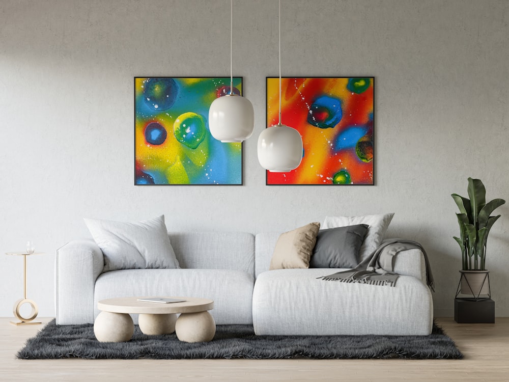 a living room with two paintings on the wall