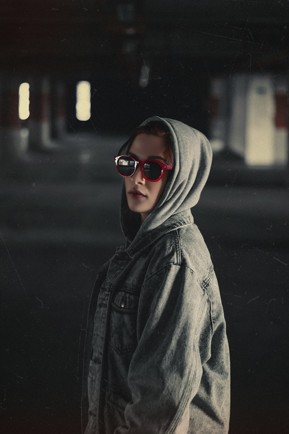a young boy wearing sunglasses and a hoodie