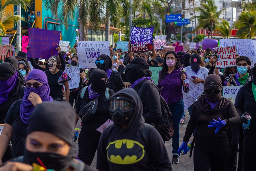 a large group of people walking down a street