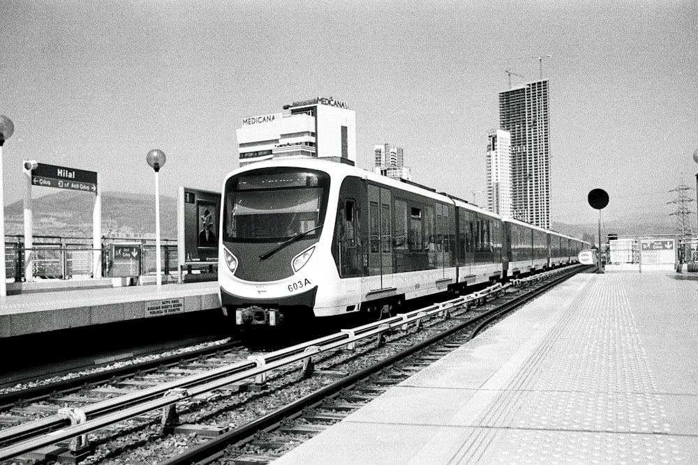 a black and white photo of a train on the tracks