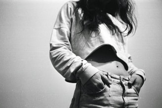 a black and white photo of a woman's stomach