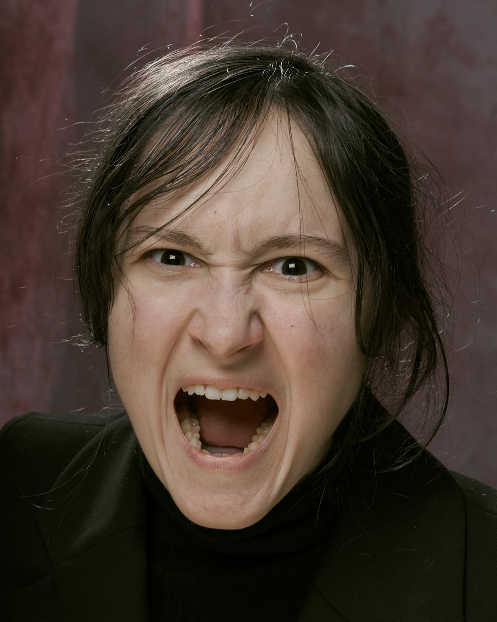 a woman with her mouth open making a face