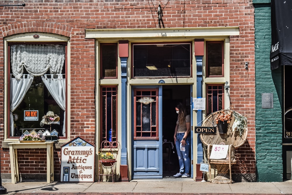 a woman standing in the doorway of a store