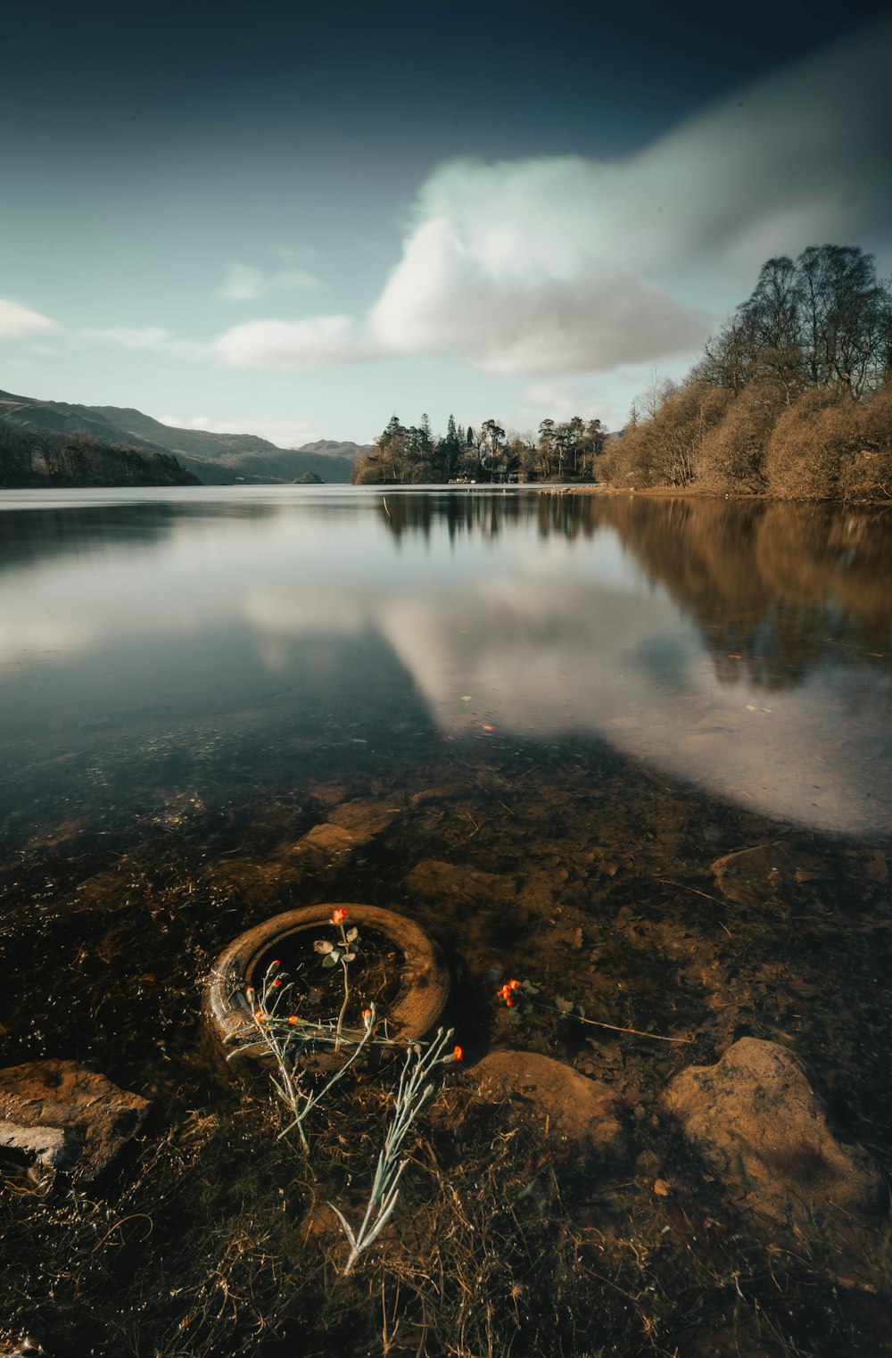 a boat is sitting on the shore of a lake