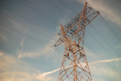 a high voltage power line against a blue sky