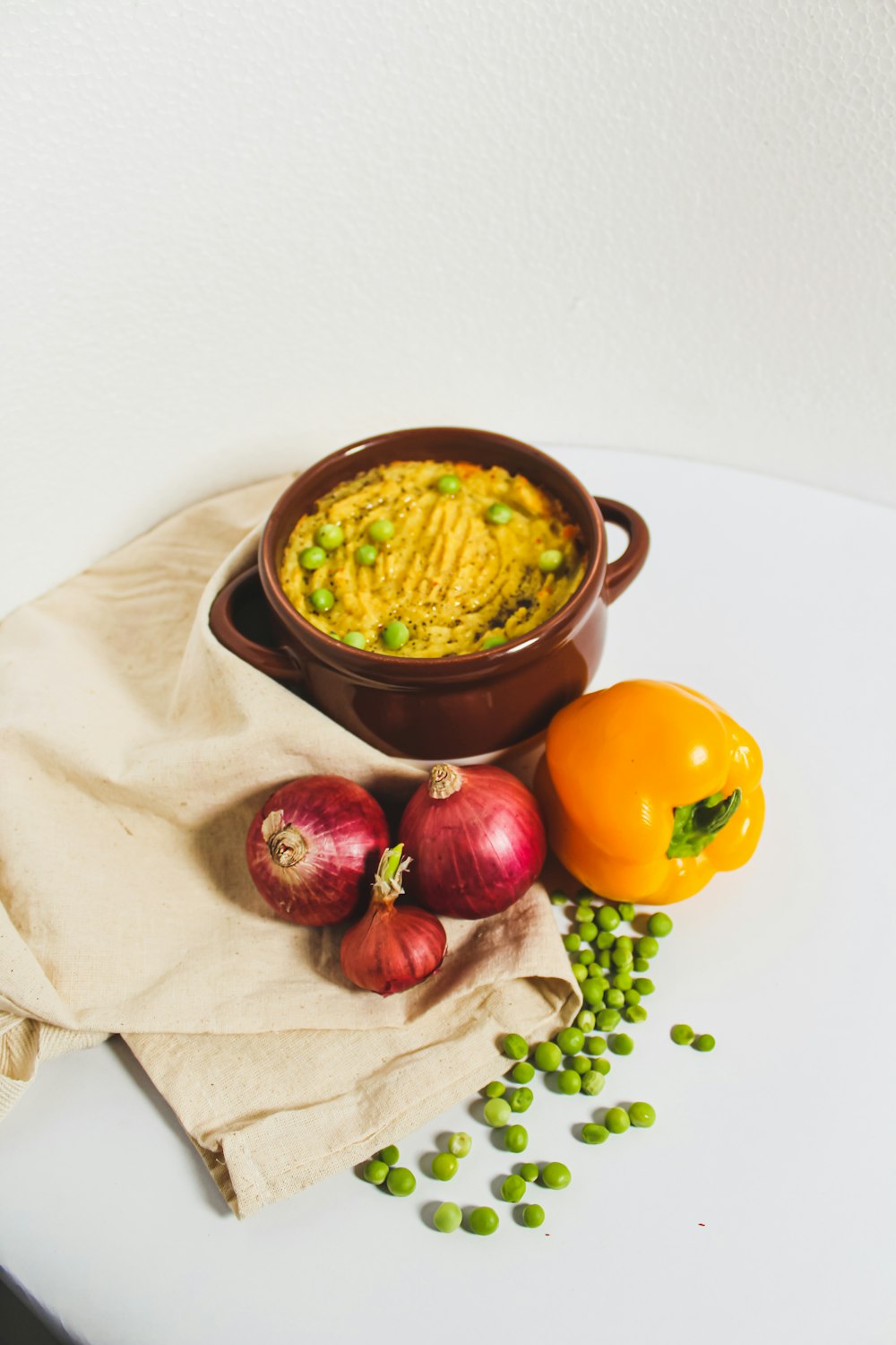 a white table topped with a bowl of food