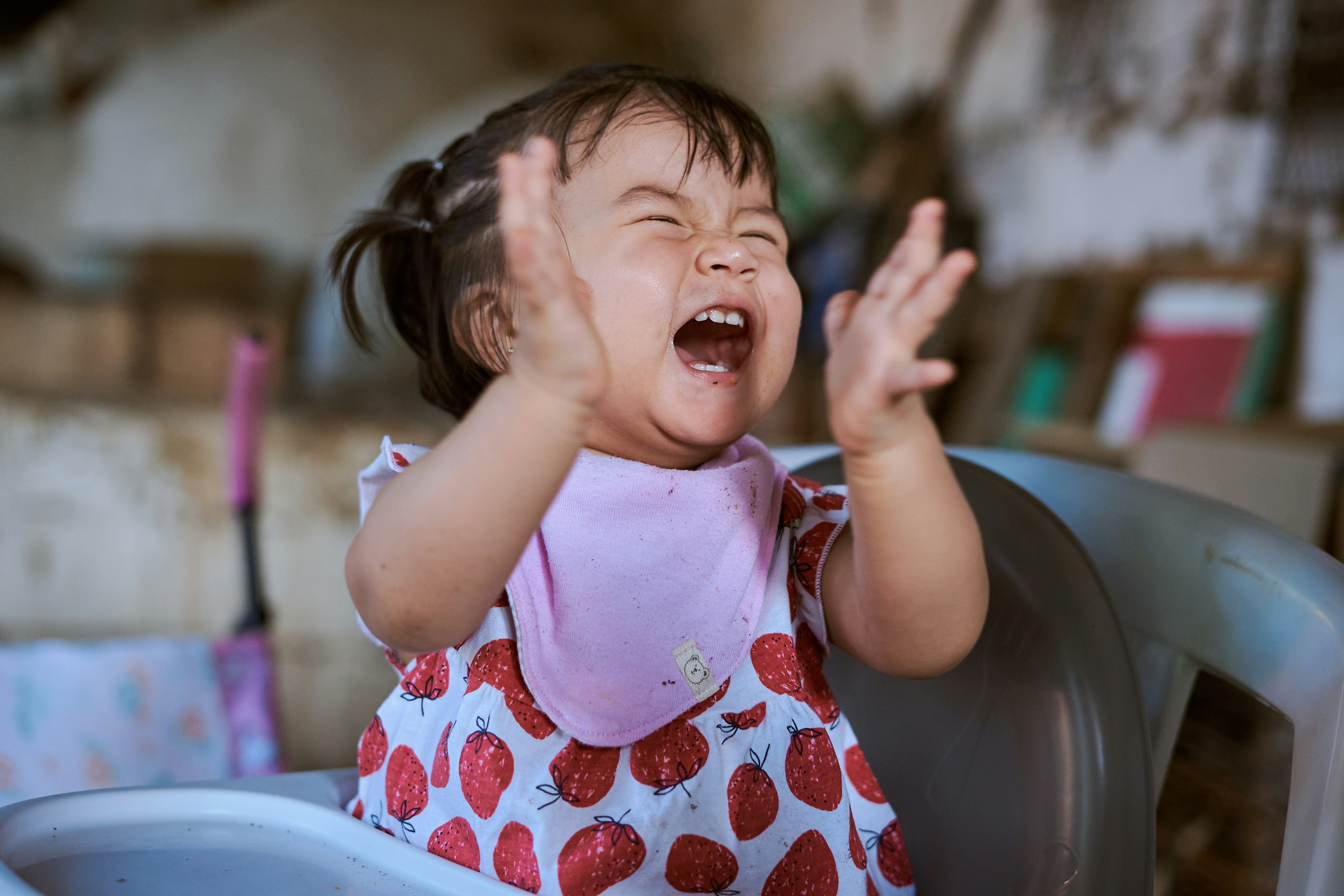A niece laughing while reading a funny birthday card