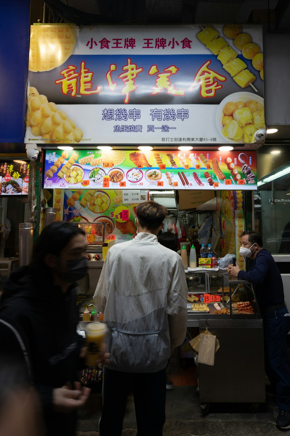 a man standing in front of a food stand