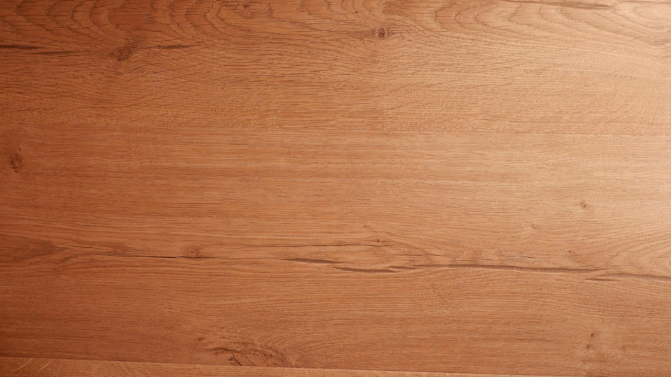 A warm, handcrafted wooden kitchen countertop with natural grain details.