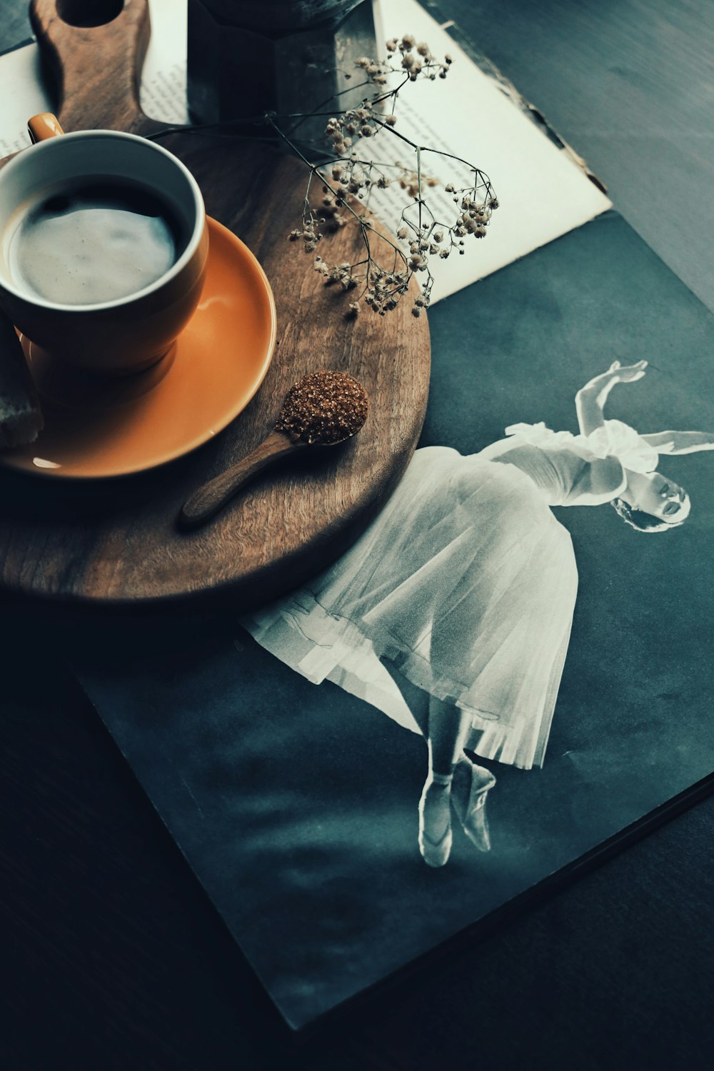 a cup of coffee sitting on top of a wooden table