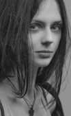 a black and white photo of a woman with long hair