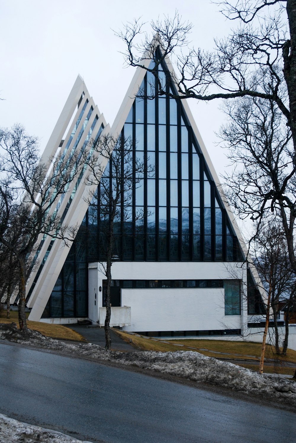 a large white building with a triangular roof