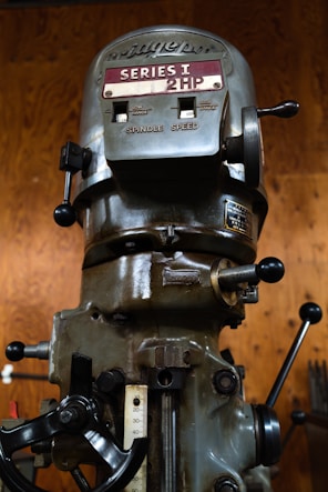 a close up of a machine with a wooden background