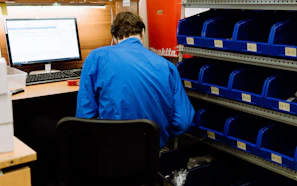 a man sitting at a desk in front of a computer