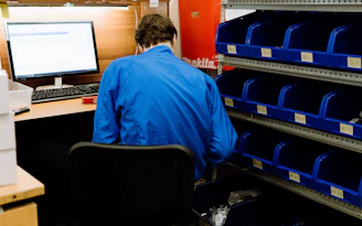 a man sitting at a desk in front of a computer